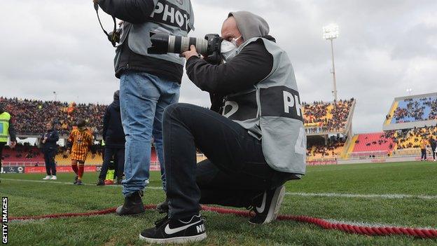 Photographer in mask