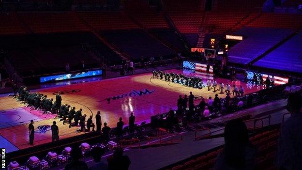 Miami Heat and Boston Celtics players kneel during the national anthem before their game on 6 January