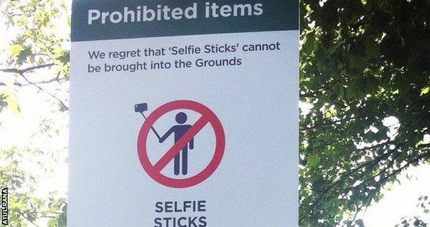 A sign shows selfie sticks are banned