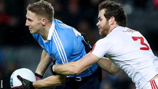 Dublin forward Eoghan is tackled by Tyrone's Ronan McNamee in Saturday night's league clash