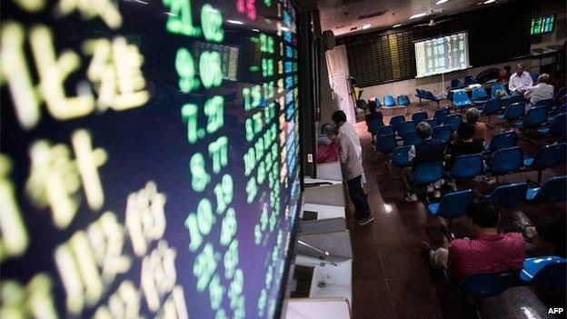 This photo taken on July 6, 2015 shows investors monitoring stock market movements at a brokerage house in Shanghai.