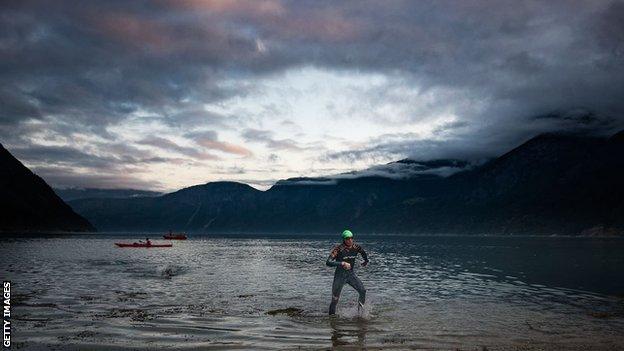 A swimmer exits the water