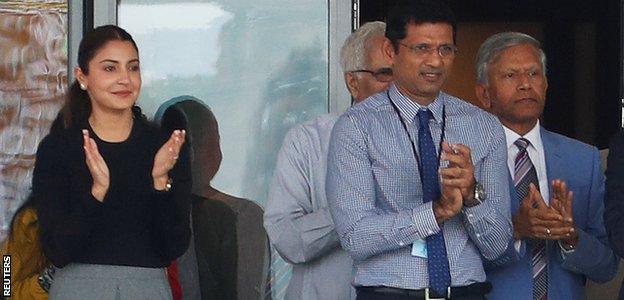 Virat Kohli blew a kiss to his wife, Anushka Sharma (left), after bringing up his century