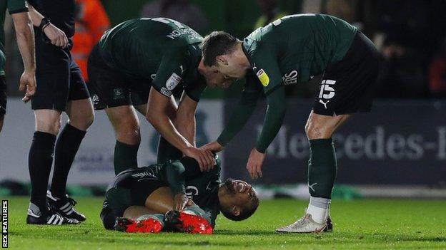 Brendan Galloway lies down injured