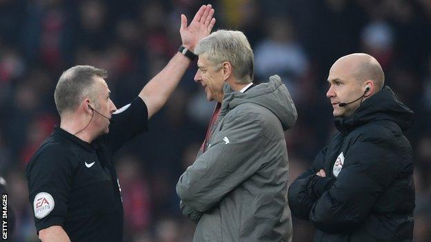 Arsenal manager Arsene Wenger (centre) is sent to the stands by referee Jon Moss during the game against Burnley