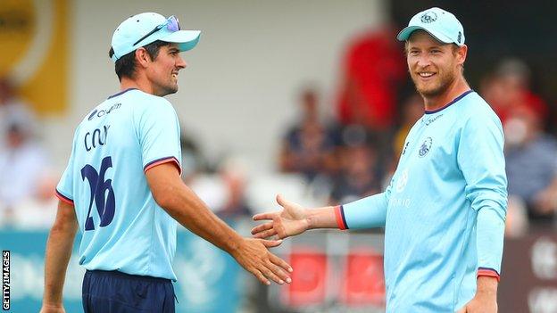 Alastair Cook (left) greets Essex team-mate Tom Westley