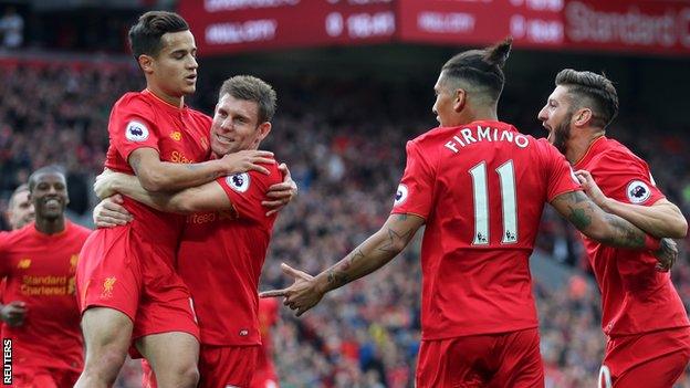 Liverpool players celebrate James Milner's (second from left) converted penalty