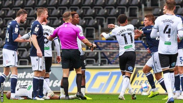 Swansea and Millwall players clash with Andre Ayew on the turf following an off-the-ball incident involving Jake Cooper