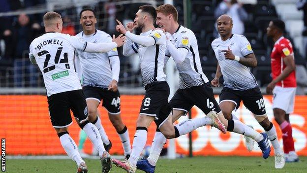 Matt Grimes celebrates after scoring his fifth goal of the season