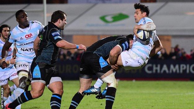 Racing 92 fly-half Dan Carter is tackled by Glasgow centre Alex Dunbar