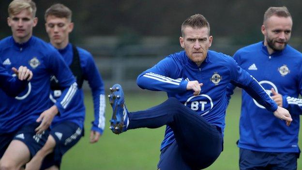 Steven Davis limbers up in training this week ahead of the Slovakia game