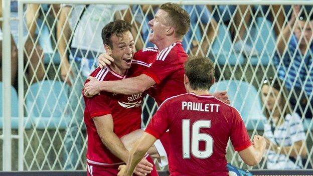 Andrew Considine (left) celebrates opening the scoring for Aberdeen against Rijeka