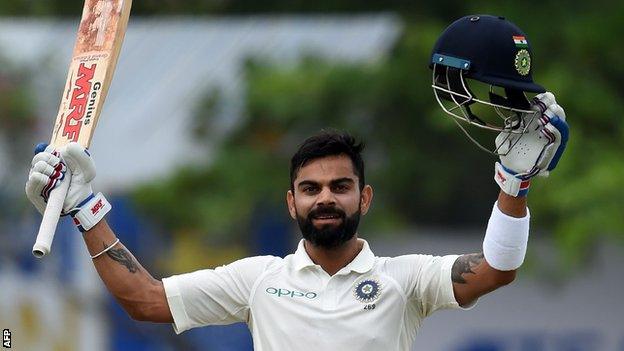 Virat Kohli celebrates hitting a century