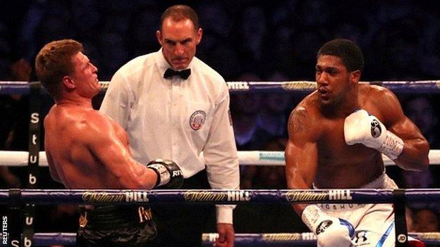 Anthony Joshua beat Alexander Povetkin to retain world heavyweight titles at Wembley Stadium