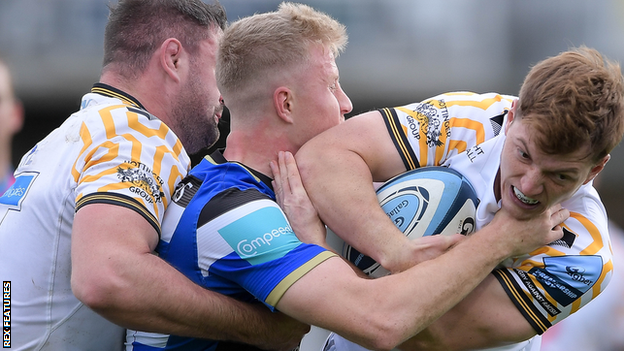 Wasps replacement scrum-half Will Porter is tackled by Bath opposite number Ollie Fox