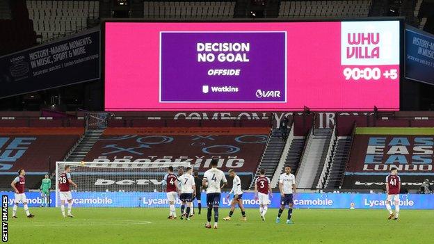 The big screen displays the 'No Goal' decision made by the Video Assistant Referee (VAR) against Ollie Watkins during the Premier League match between West Ham United and Aston Villa