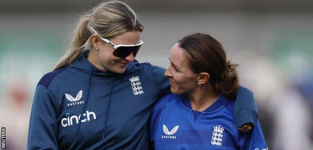 Lauren Bell and Kate Cross talk on the pitch