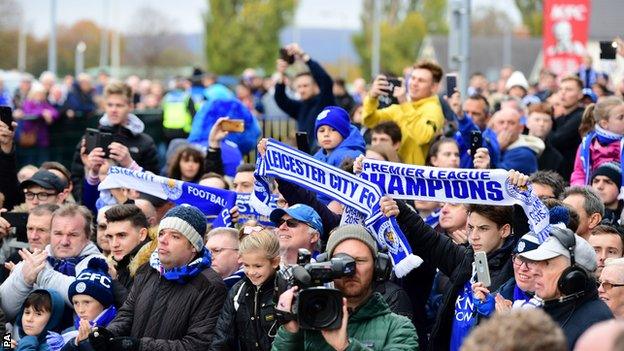 Leicester fans raise flags commemorating their Premier League success in 2015-16