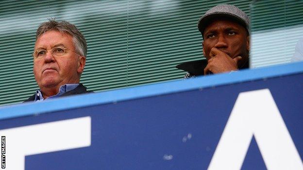 Didier Drogba watches a match with Guus Hiddink