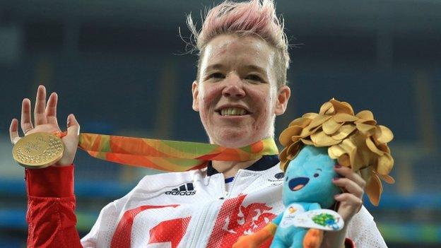 Jo Butterfield celebrates with her gold medal in the club throw