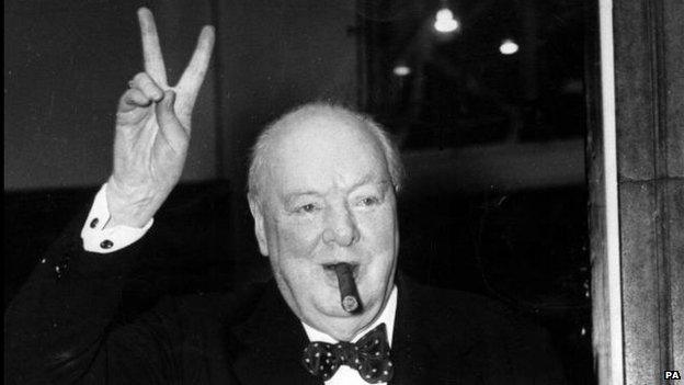 Churchill in famous V for Victory salute with cigar