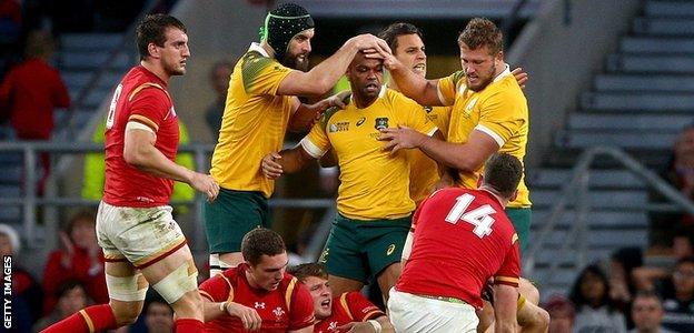 Australia players celebrate after winning a penalty against Wales