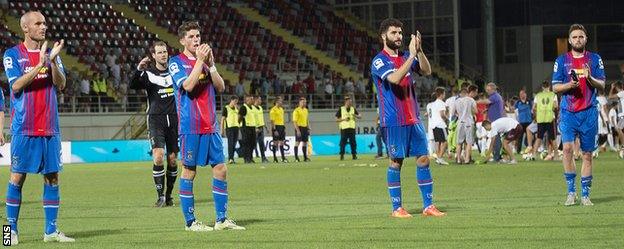 Caley Thistle players applaud their fans