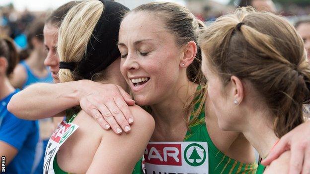 Kerry O'Flaherty embraces Ireland team-mates Lizzie Lee and Fionnuala McCormack after the recent team bronze success at the European Cross Country Championships