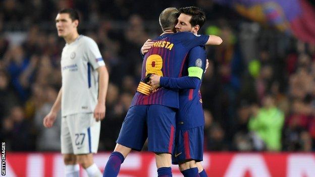 Andres Iniesta of Barcelona hands the captain's armband to Lionel Messi