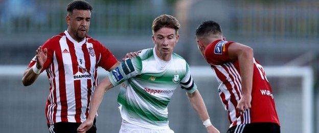 Shamrock Rovers midfielder Ronan Finn is challenged by Derry's Darren Cole and Cathal Farren