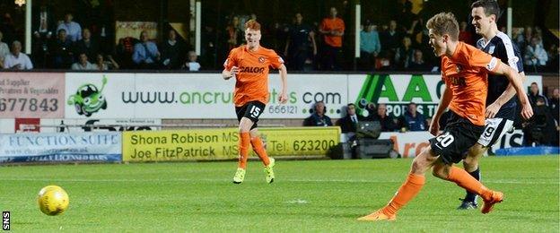 Blair Spittal slots home his second goal for Dundee United against Dundee