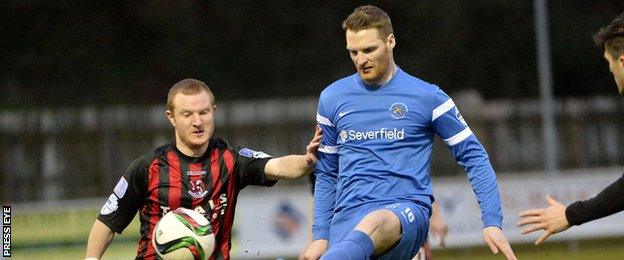 David Magowan and Cathal Beacom battle for possession at Ferney Park