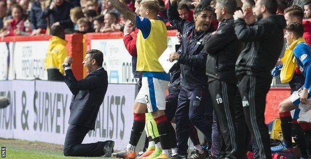 Pedro Caixinha falls to his knees to celebrate as Rangers score a third goal to stun Aberdeen at Pittodrie