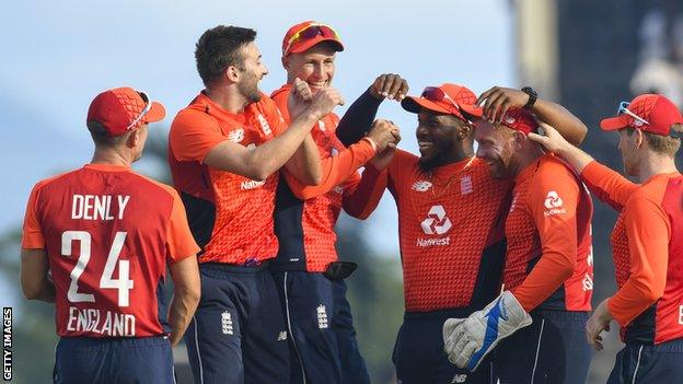 England players celebrate taking a wicket