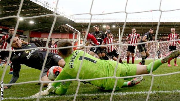 Dean Henderson makes a save against Norwich