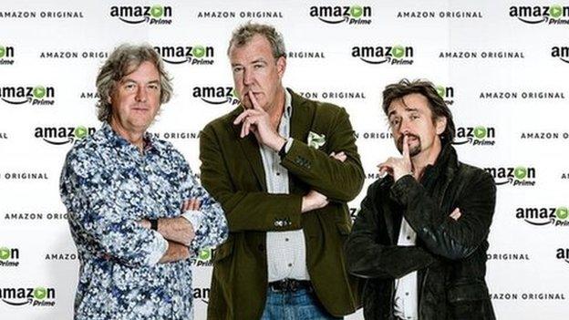 James May, Jeremy Clarkson and Richard Hammond in front of Amazon Prime backdrop