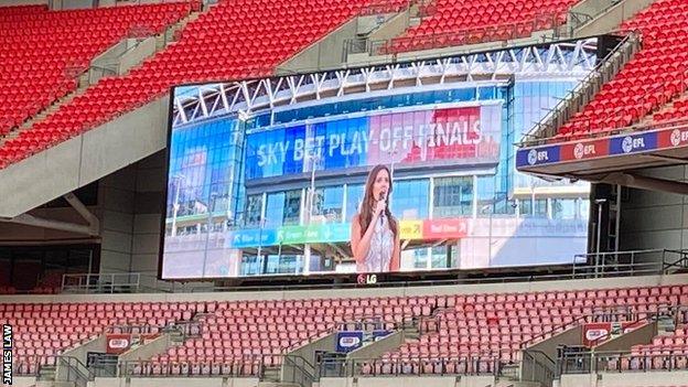 The national anthem is sung over Wembley's big screens