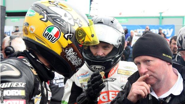 Mervyn Whyte (right) talks to riders Guy Martin and Bruce Anstey at the North West 200 in 2011