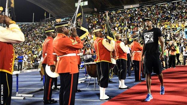 Usain Bolt is welcomed at the stadium in Kingston