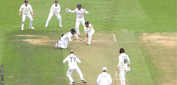 Ollie Pope takes a catch to dismiss Daryl Mitchell