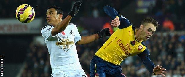 Jefferson Montero (left) takes on Arsenal's Calum Chambers during Swansea's 2-1 win in November 2014