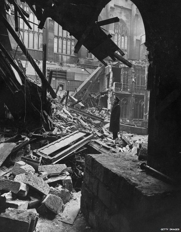 A man standing amidst the debris at the Houses of Parliament