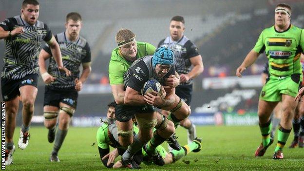 Justin Tipuric is hauled down by desperate Northampton defenders