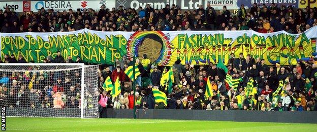 Norwich City fans raise a Justin Fashanu banner