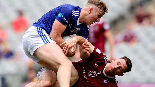 Cavan forward Paddy Lynch wrestles for possession with Westmeath defender James Dolan