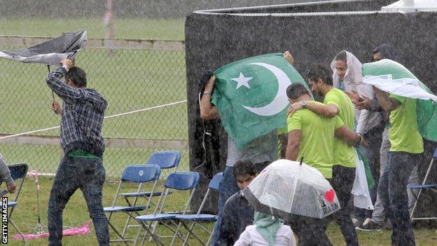 Pakistan fans shelter from the rain