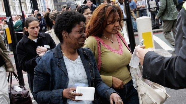 Shocked commuters with blackened faces walk away from Edgware Road