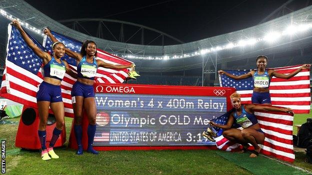 United States athletes celebrate gold in the women's 4x400m relay