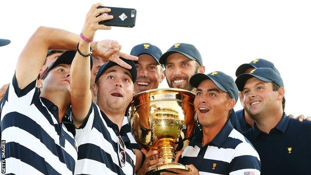 The U.S. Team celebrates with the trophy after they defeated the International Team 19 to 11 in the Presidents Cup at Liberty National Golf Club on October 1, 2017 in Jersey City, New Jersey.