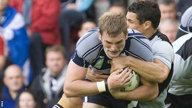 John Barclay of Scotland is tackled by New Zealand's Dan Carter